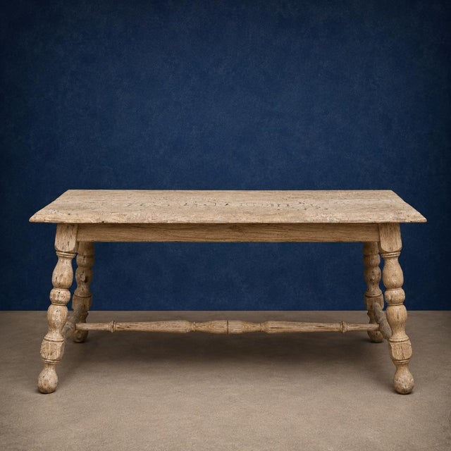This 19th Century French Oak Provincial Coffee Table showcases the timeless charm of rustic European craftsmanship with...