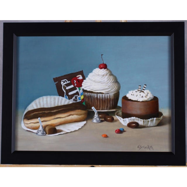This oil on panel artwork presents a delightful still life of various confections, including a decadent cupcake topped...