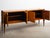 Four-door credenza designed by Pier Luigi Colli. The piece features carved column supports with decorative detailing,...