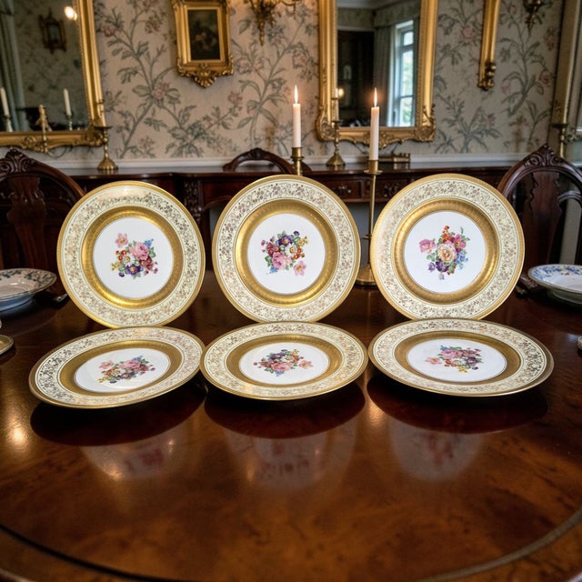 This elegant set of 6 vintage (ART B China) round porcelain dishes features a heavily gilded border and floral center...