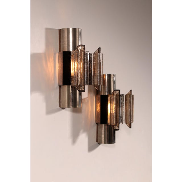 A rare pair of Danish Space Age or Brutalist wall lamps designed by Claus Bolby and manufactured by his own lighting...