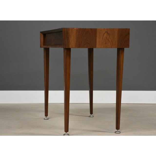 A mid century modern walnut desk or vanity with a single drawer by Grosfeld House. Made in USA. Circa 1960’s....