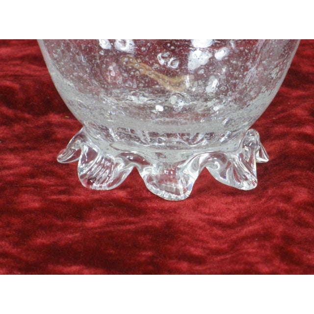 The product is a vintage Venetian clear small footed glass nut bowl, made in Italy during the 1920s. This round bowl...