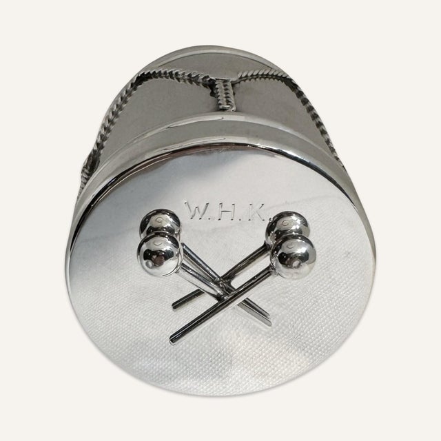 This vintage Cartier box was produced in the 1940s. This box is shaped like a drum with applied sterling decoration...