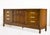 A low, long, and quietly commanding presence — this 1970s Campaign style lowboy dresser by Henry M. Goodman Furniture is...