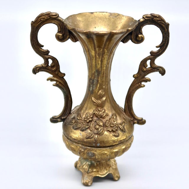 A small vintage Italian urn vase with dramatic scrolled twin handles and a delicate floral garland across the body, raised...