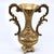 A small vintage Italian urn vase with dramatic scrolled twin handles and a delicate floral garland across the body, raised...