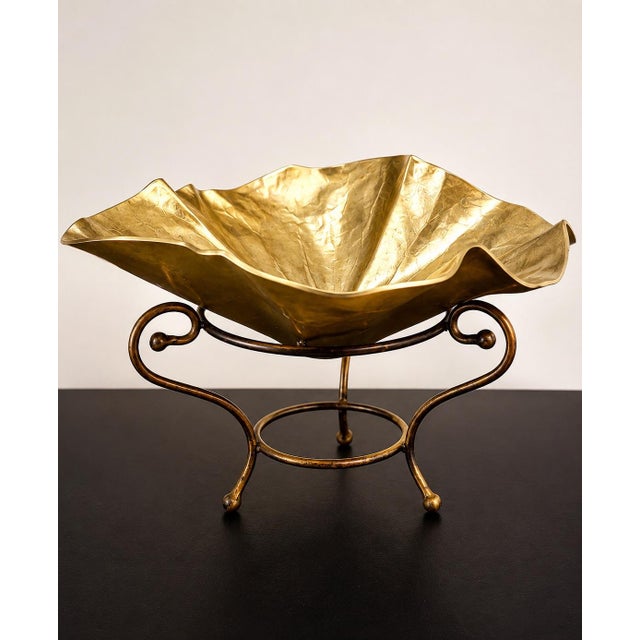 Elegant vintage-style gold-tone brass gondola bowl featuring a graceful elongated shape and decorative detailing. This...