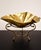 Elegant vintage-style gold-tone brass gondola bowl featuring a graceful elongated shape and decorative detailing. This...