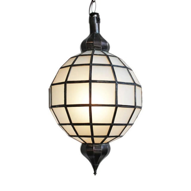 White frosted glass and metal work lantern. Includes 3' chain and black ceiling plate. 100 watt max fixture. Bulb not...