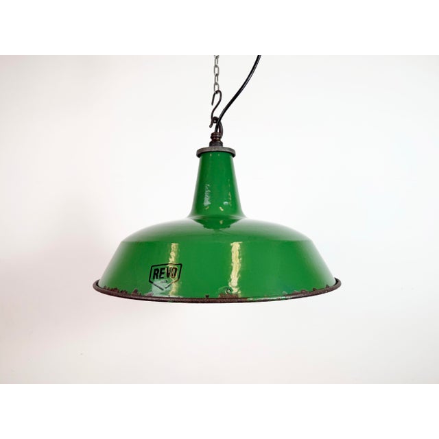 Industrial green enamel pendant light made by revo in united kingdom during the 1950s. White enamel inside the shade. Iron...