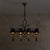 A French hand-forged wrought iron chandelier from the 1940s. Suspended from an iron chain, the chandelier unfolds outward...