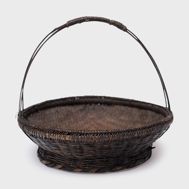 Woven with precious scale and delicate artistry, this small flower basket from the early 20th century is a charming...