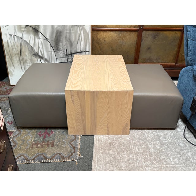 Design Plus Gallery presents the Bowery Ottoman from Maiden Home. The ottoman has a dark gray leather and rectangular base...