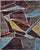 Intersecting ivory lines divide this handmade wool rug into irregular geometric shapes. Deep burgundy and plum-brown...