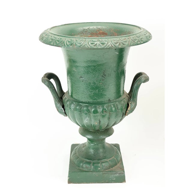 17.25H x 12.25D A wonderfully decorative matched pair of 19th-century cast iron garden urns in the Neoclassical taste,...