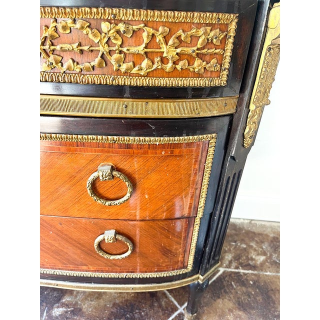 French Louis XVI-style marble-top commode with gilt-bronze mounts. Circa 1870, ebonized frame, diagonal veneer, made...