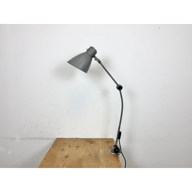 Large industrial table lamp with three adjustable joints made in former Czechoslovalia during the 1960s.It features a grey...