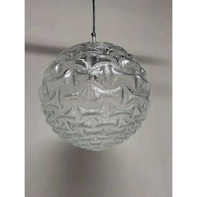 Beautiful large vintage pendant lamp by the German company Doria Leuchten. Beautiful glass work which creates an...