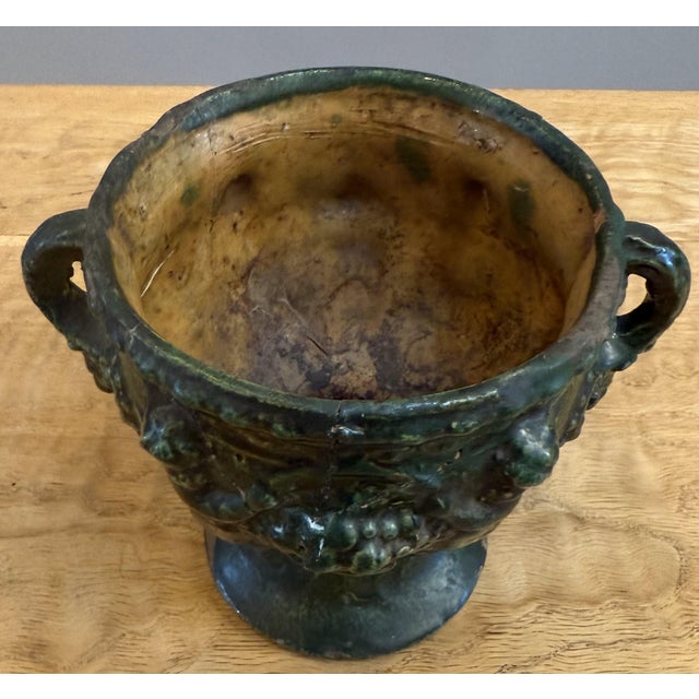 Small Spanish Colonial Neoclassical Ceramic Urn. Two handles with lion heads and cherub details. Made in Peru circa 1640....