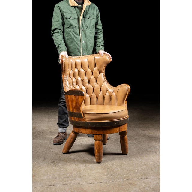 c. 1940s/1950s; barrel is sourced from Continental Baking Co. - Wheeling, WV Vintage tufted leather armchair set in a...