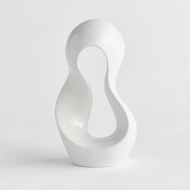 This wellscaled clay sculpture is an abstract, curvy composition finished in a shinyWhite glaze. A simple, yet...