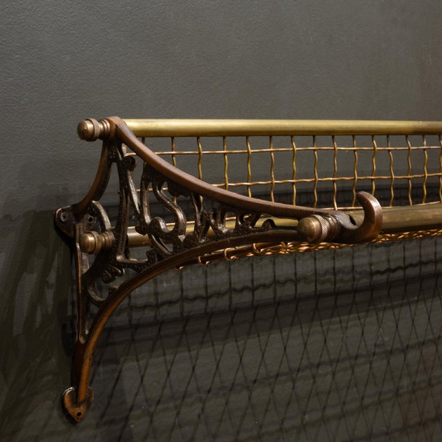 ABOUT A vintage wall mounted luggage rack made of solid cast iron and solid brass frame with woven brass mesh. Cast iron...