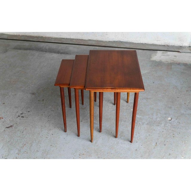 Set of 3 nesting tables designed and produced in Denmark during the 1960’s. These dark teak veneer tables are an elegant...
