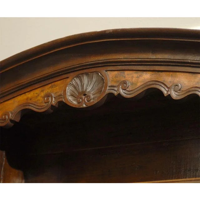 A French restoration period early 19th century walnut vaisselier from the Bressan region with bonnet crest, molded doors...