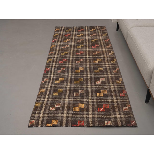 Vintage Hand-Knotted runner rug is a semi-antique vintage area rug. The '70s Eastern region of Anatolia's unique rug is...