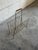 Beautiful vintage Danish magazine rack crafted in brass-tone metal with a teak handle. This elegant Scandinavian modern...