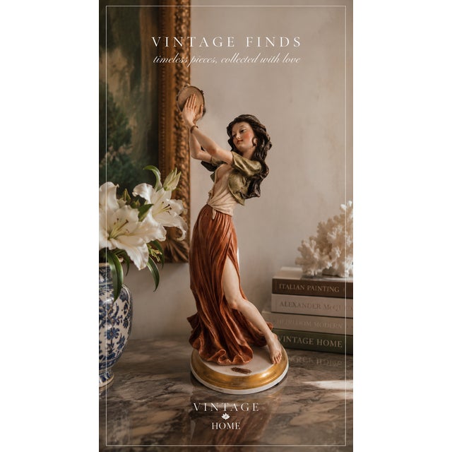 Elegant vintage figurine depicting a graceful tambourine dancer in flowing garments with beautiful hand-painted details...