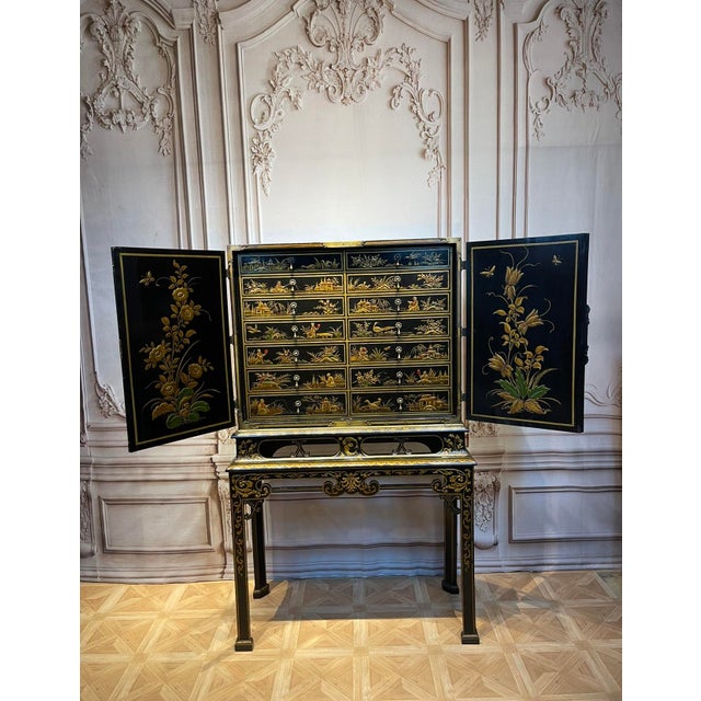 Exceptional English Chinoiserie Cabinet on Stand. Two Parts, the upper collectors cabinet of black lacquer with oriental...