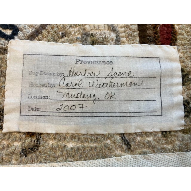 This hand hooked rug was Created by Carol Weatherman ( 1950-2024) Signed by her entitled “ Harbor Scene” 2017 This is an...