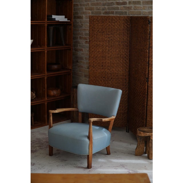 Elevate your interior space with this Danish Modern masterpiece - an exceptional curved lounge chair in oak attributed to...