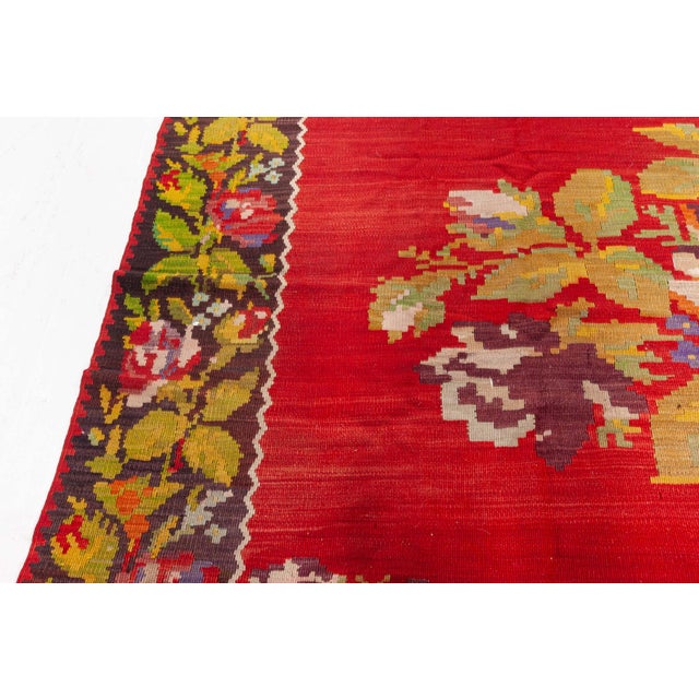 Bold, expressive, and rich in cultural heritage, this antique Bessarabian rug from the 1930s is a striking example of...