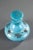 Turquoise blue opaline flask and its flattened stopper that is decorated with a radiant pattern. Gold stripes decorate the...