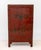 Chinese Red Lacquered Cabinet, with gilt decorated figural courtyard scene, the two doors opening to one shelf. 63" H x...