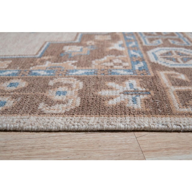 Exquisite Kiran Beige Hand Knotted Wool Rug, Country of Origin: India. This piece offers a sophisticated interpretation of...