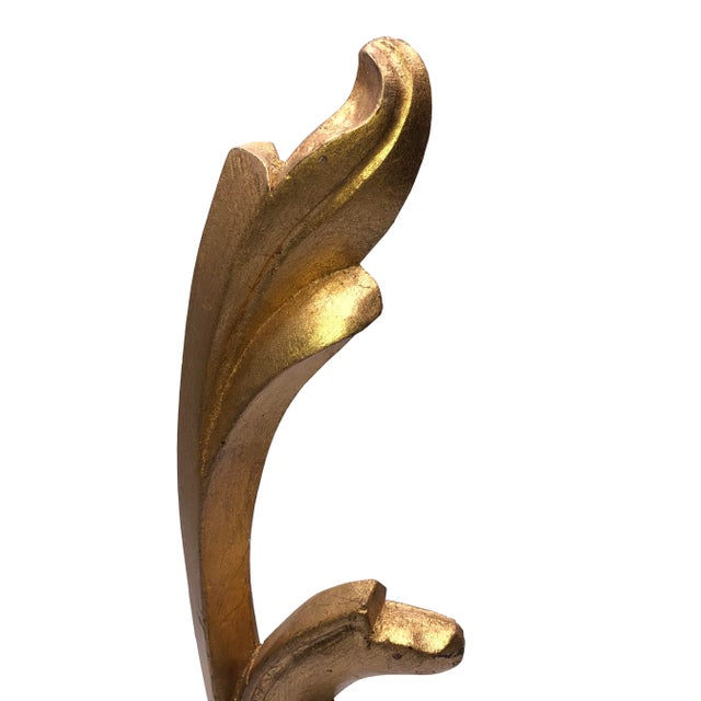 A vintage architectural gilded wood French scroll design fragment mounted on a marble base.
