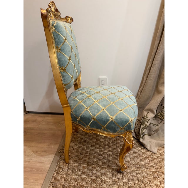 An elegant mid-20th-century Louis XV Revival chair, likely of French origin.. featuring richly carved giltwood with...