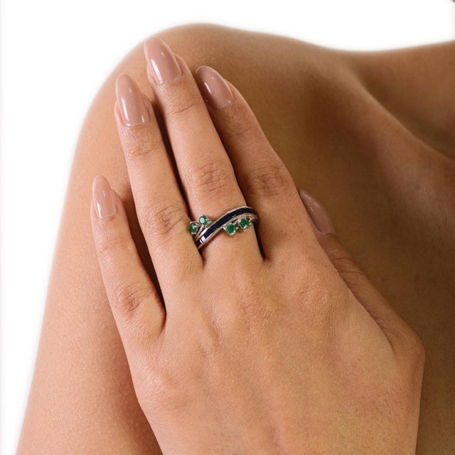 This elegant band ring is crafted in 925 sterling silver and features a striking combination of blue sapphires and...