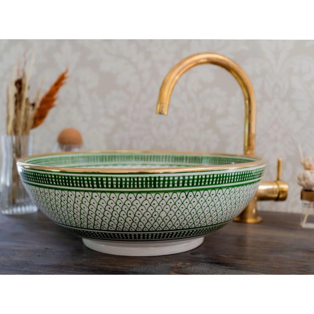 1) Elevate the Beauty of your bathroom with our 14 karat gold Rim Sink. This ceramic vessel sink is skillfully handcrafted...