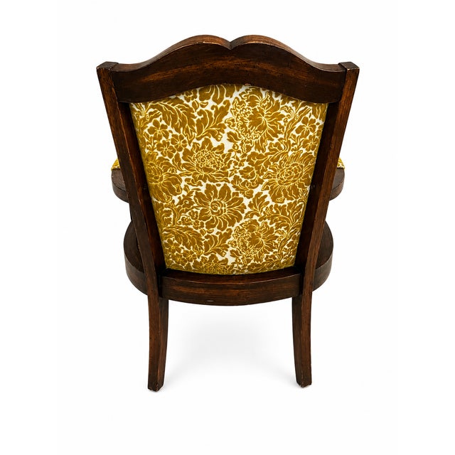 A vintage mid-century modern cane armchair, likely manufactured in the 1960s or 1970s. It features a dark-stained carved...