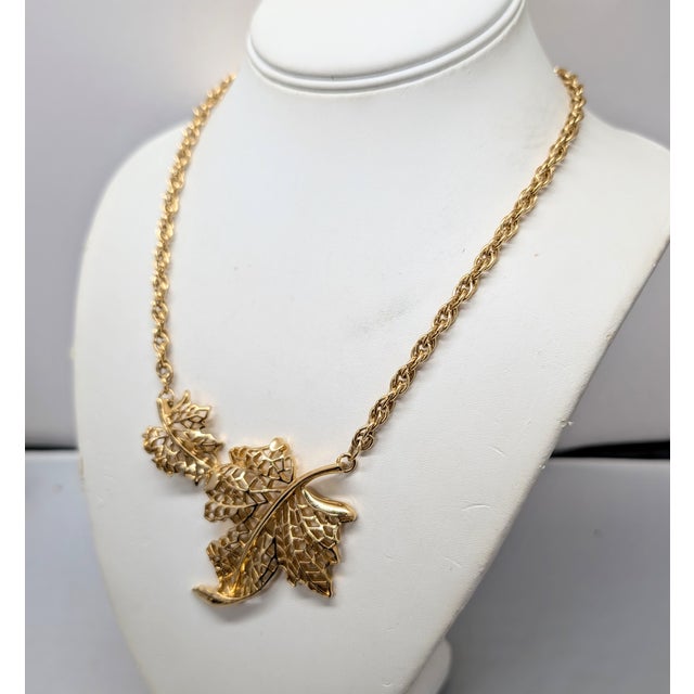 L:ate 1970s or early 1980s goldtone two openwork leaves with curled edges one bigger than the other on a chain necklace...