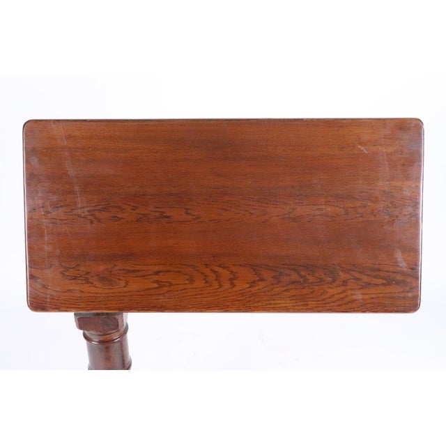 Victorian English oak tilt top reading table with adjustable height and tilt. The support pedestal features lathe turned...