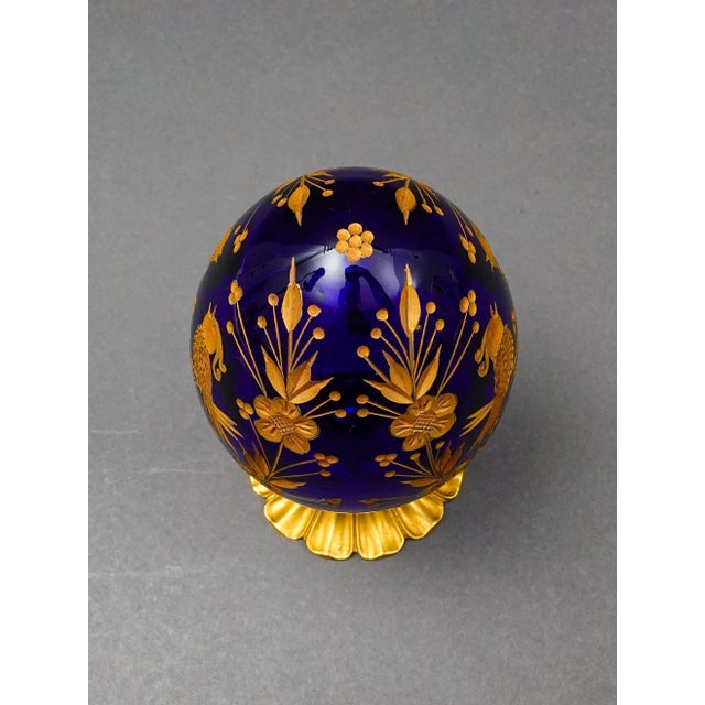 Style Of Faberge Cobalt Blue Cut Crystal Gold Gilt Floral Love Birds Egg. Measures approximately 3 1/2" diameter, 7 5/8"...