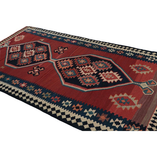 Handwoven in wool, circa 1950-1960, this 5x10 Afghani tribal Kilim rug, with medallion and open field style together, is a...