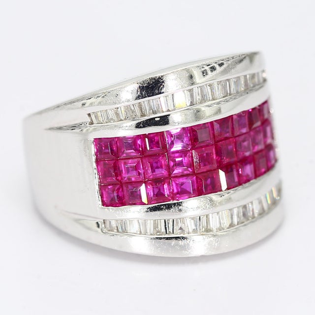 This is an eye catching ring with three rows of princess cut lab rubies, and two more rows of tapered baguette diamonds...