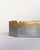 Designed by David Marshall, this square brass ashtray pairs a heavily textured brass frame with a smooth aluminium centre....
